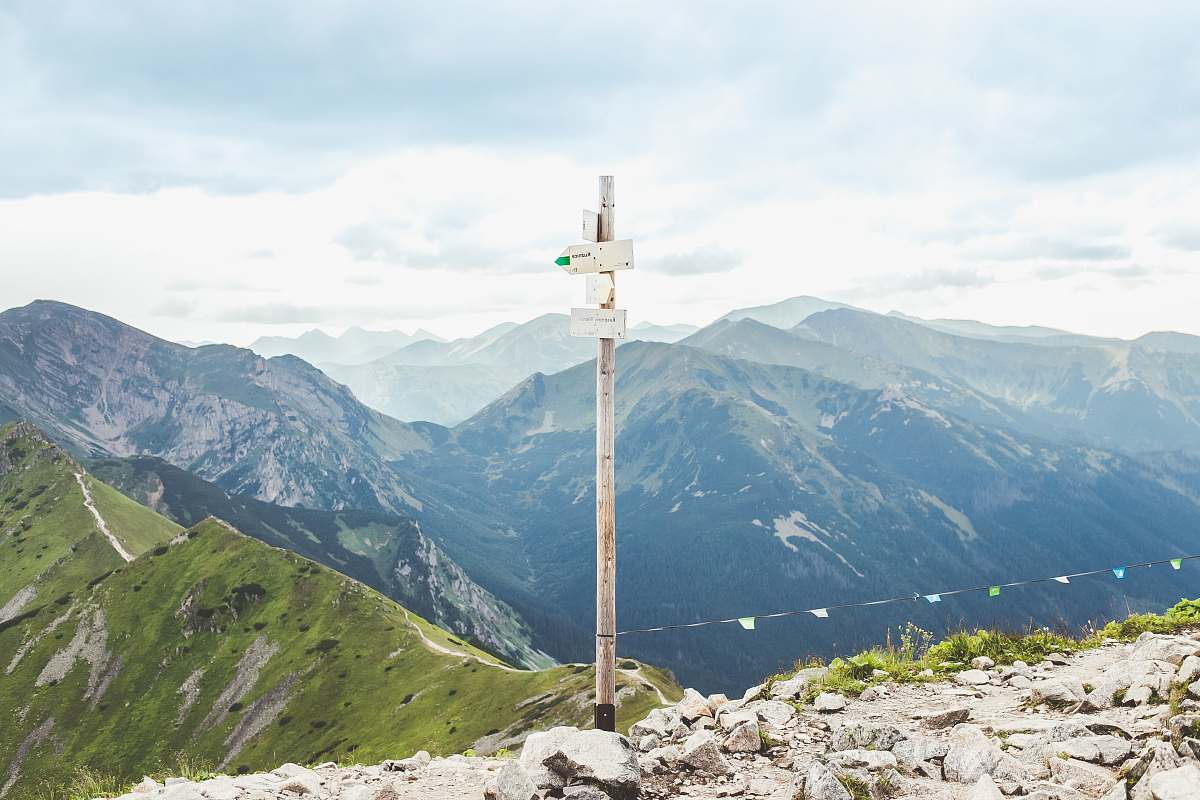 mountain range white signage on top of mountain peak